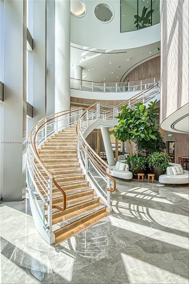 15701 Collins Ave Unit 1603, Sunny Isles Beach, FL 33160 - staircase with a high ceiling and marble tiled flooring