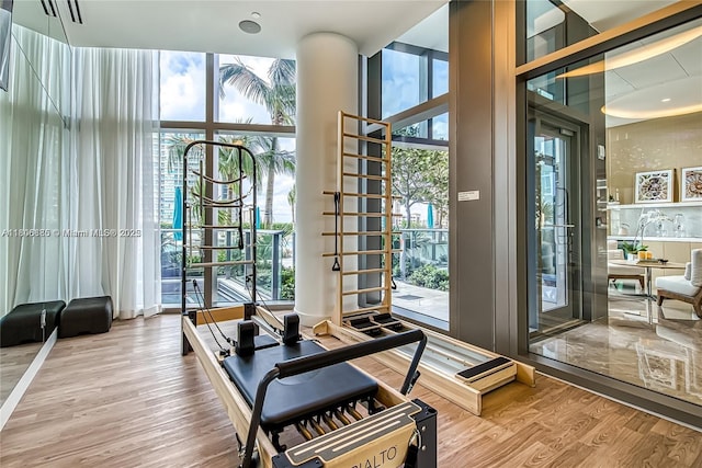 15701 Collins Ave Unit 1603, Sunny Isles Beach, FL 33160 - workout area with wood finished floors, expansive windows, and a towering ceiling