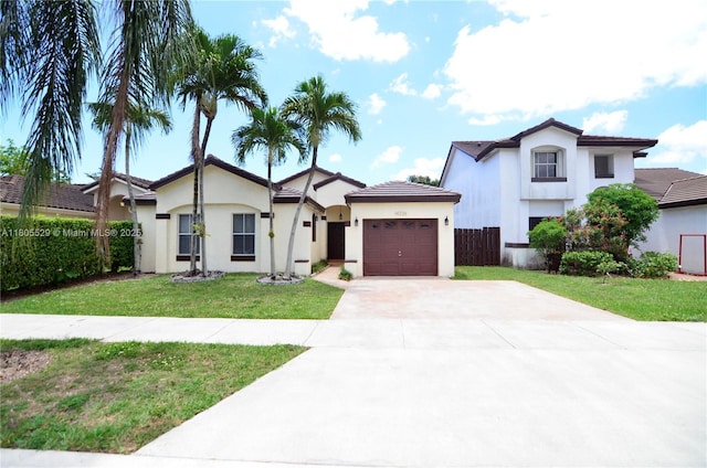 14226 SW 90th Ter, Miami, FL 33186 - view of front of house with an attached garage, stucco siding, concrete driveway, and a front yard