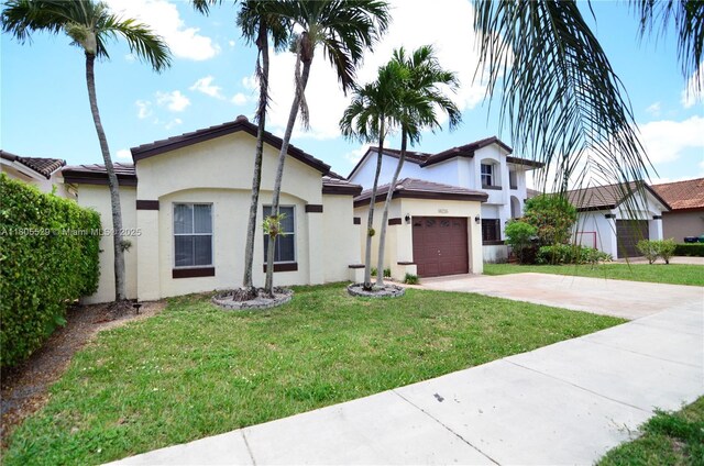 14226 SW 90th Ter, Miami, FL 33186 - view of front of house with driveway, stucco siding, a front lawn, and an attached garage