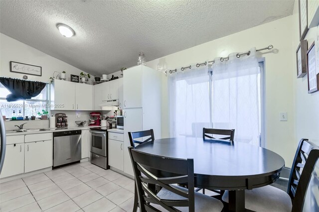 14226 SW 90th Ter, Miami, FL 33186 - kitchen with appliances with stainless steel finishes, a textured ceiling, lofted ceiling, a sink, and under cabinet range hood