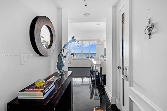 848 Brickell Key Dr Unit 3803, Miami, FL 33131 - corridor featuring baseboards and granite floors