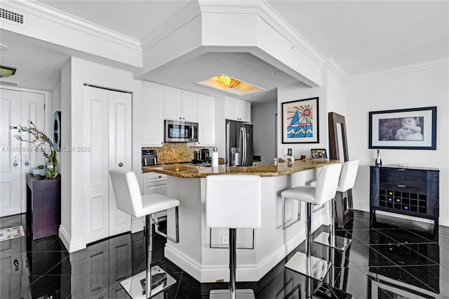 848 Brickell Key Dr Unit 3803, Miami, FL 33131 - kitchen with granite floors, stainless steel appliances, baseboards, a kitchen breakfast bar, and crown molding