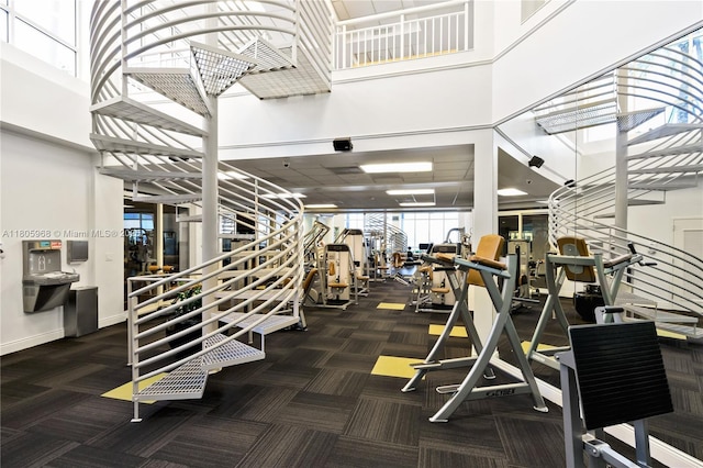848 Brickell Key Dr Unit 3803, Miami, FL 33131 - gym with carpet flooring, a towering ceiling, and baseboards