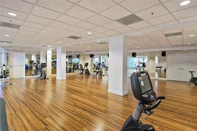 848 Brickell Key Dr Unit 3803, Miami, FL 33131 - gym with wood finished floors, ornate columns, and a drop ceiling