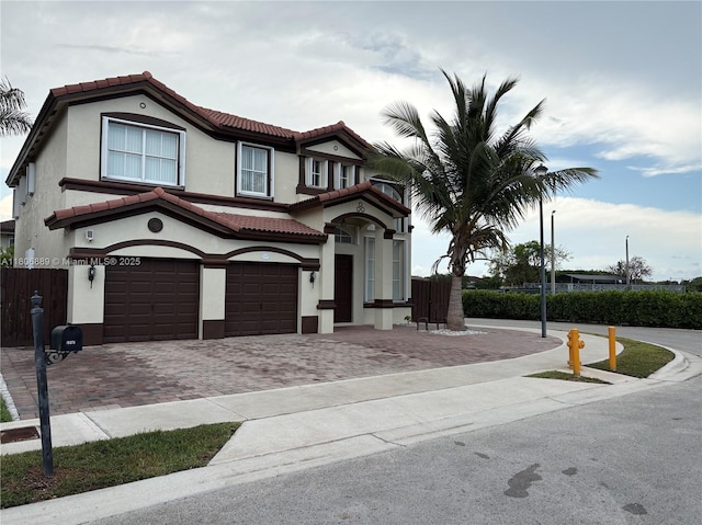 15375 SW 93rd Ln, Miami, FL 33196 - view of front of house featuring an attached garage, a tiled roof, decorative driveway, and stucco siding