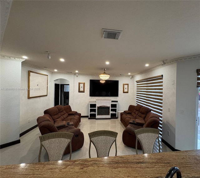 15375 SW 93rd Ln, Miami, FL 33196 - living area featuring ornamental molding, recessed lighting, a fireplace, arched walkways, and light tile patterned floors
