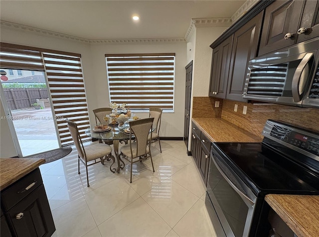 15375 SW 93rd Ln, Miami, FL 33196 - kitchen with stainless steel appliances, light tile patterned floors, light countertops, dark brown cabinetry, and recessed lighting