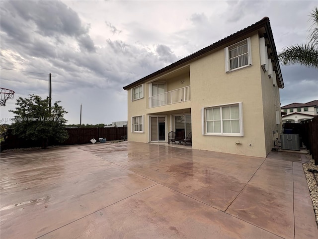 15375 SW 93rd Ln, Miami, FL 33196 - rear view of house featuring stucco siding, a fenced backyard, a balcony, and a patio area