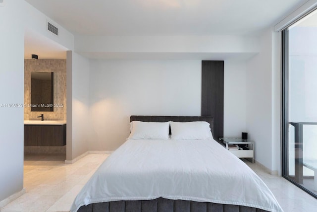 88 SW 7th St Unit 2707, Miami, FL 33130 - bedroom featuring ensuite bathroom, baseboards, and light tile patterned floors