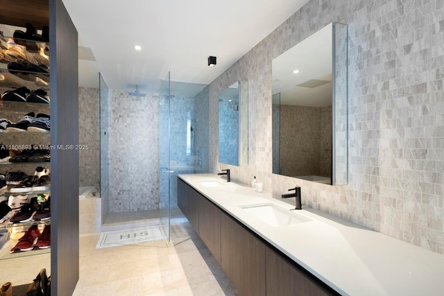 88 SW 7th St Unit 2707, Miami, FL 33130 - full bath with tile walls, a shower stall, tile patterned flooring, double vanity, and a walk in closet