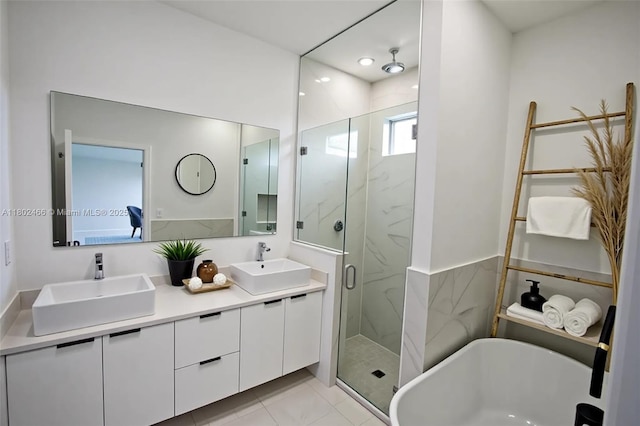 9016 E Justice Cir, La Belle, FL 33935 - full bath featuring a marble finish shower, a soaking tub, double vanity, and tile patterned floors