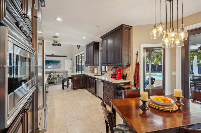 11898 SW 74th Ter, Miami, FL 33183 - kitchen with dishwasher, a sink, dark brown cabinets, tasteful backsplash, and recessed lighting