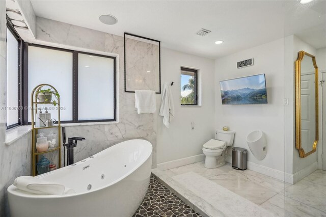 11898 SW 74th Ter, Miami, FL 33183 - bathroom featuring marble tiled flooring, a soaking tub, toilet, and baseboards
