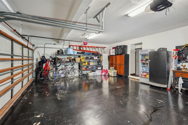 11898 SW 74th Ter, Miami, FL 33183 - garage featuring a garage door opener and freestanding refrigerator