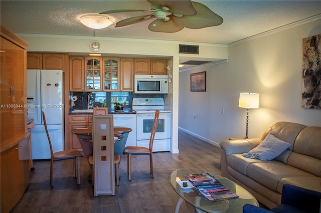 4501 Martinique Way # C1, Coconut Creek, FL 33066 - kitchen featuring white appliances, open floor plan, crown molding, glass insert cabinets, and dark wood finished floors