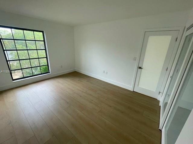 5570 NW 44th St Unit 209A, Lauderhill, FL 33319 - spare room featuring wood finished floors and baseboards
