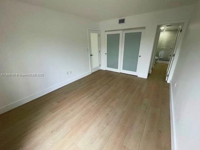 5570 NW 44th St Unit 209A, Lauderhill, FL 33319 - unfurnished bedroom with wood finished floors, a closet, and connected bathroom