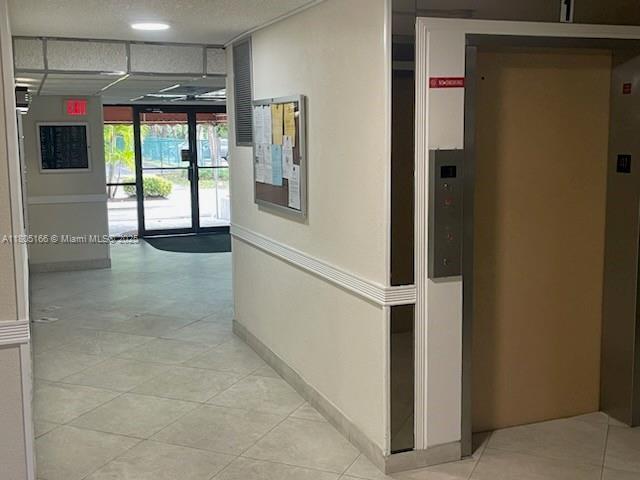 5570 NW 44th St Unit 209A, Lauderhill, FL 33319 - hall featuring elevator and light tile patterned floors