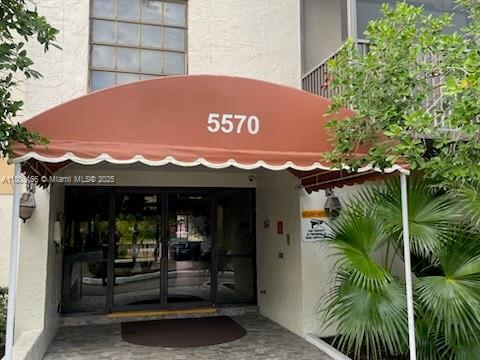 5570 NW 44th St Unit 209A, Lauderhill, FL 33319 - property entrance featuring stucco siding and french doors