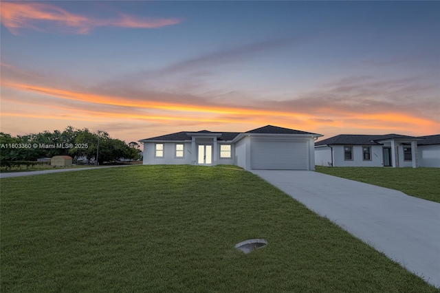 2506 5th St SW, Lehigh Acres, FL 33976 - view of front of home featuring concrete driveway, a yard, and an attached garage
