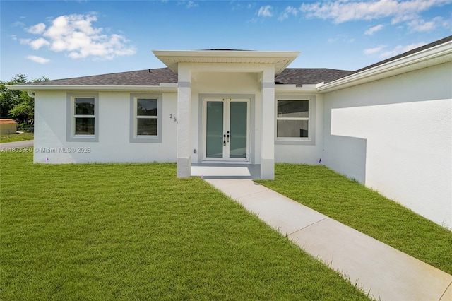 2506 5th St SW, Lehigh Acres, FL 33976 - entrance to property featuring stucco siding, a yard, and roof with shingles