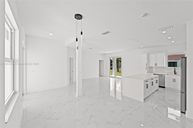 2506 5th St SW, Lehigh Acres, FL 33976 - unfurnished room with light marble finish flooring, recessed lighting, a smoke detector, and baseboards