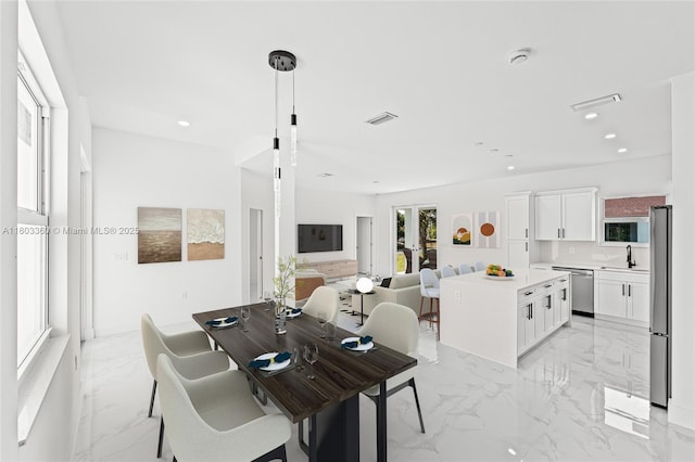 2506 5th St SW, Lehigh Acres, FL 33976 - dining area featuring light marble finish flooring and recessed lighting