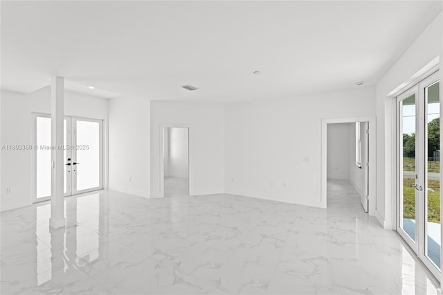 2506 5th St SW, Lehigh Acres, FL 33976 - unfurnished room featuring french doors, healthy amount of natural light, baseboards, light marble finish floors, and recessed lighting