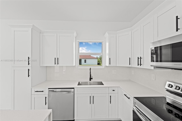 2506 5th St SW, Lehigh Acres, FL 33976 - kitchen with appliances with stainless steel finishes, a sink, light countertops, and white cabinets