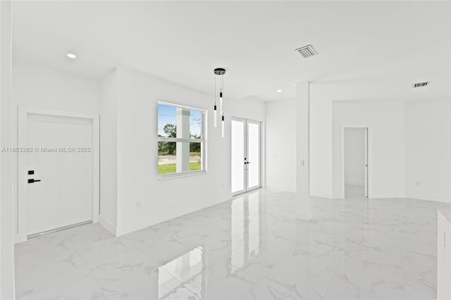 2506 5th St SW, Lehigh Acres, FL 33976 - spare room with light marble finish flooring, french doors, recessed lighting, and baseboards