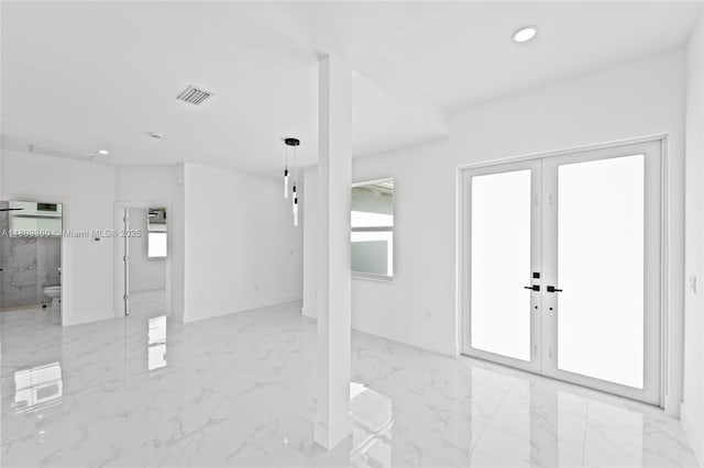 2506 5th St SW, Lehigh Acres, FL 33976 - unfurnished room with recessed lighting, marble finish flooring, baseboards, and french doors