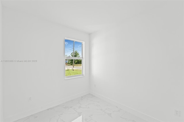 2506 5th St SW, Lehigh Acres, FL 33976 - unfurnished room with baseboards and light marble finish floors
