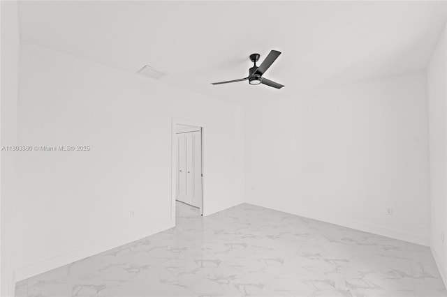 2506 5th St SW, Lehigh Acres, FL 33976 - spare room featuring light marble finish flooring, ceiling fan, and baseboards