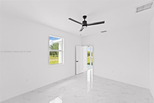 2506 5th St SW, Lehigh Acres, FL 33976 - empty room with baseboards, marble finish floors, and a ceiling fan
