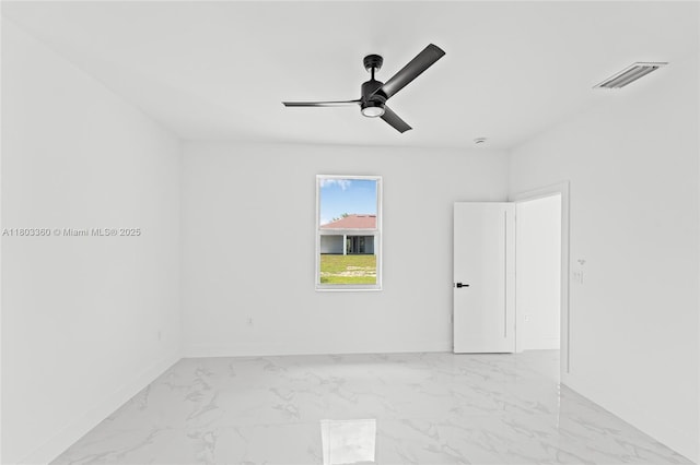 2506 5th St SW, Lehigh Acres, FL 33976 - empty room with baseboards, light marble finish floors, and a ceiling fan