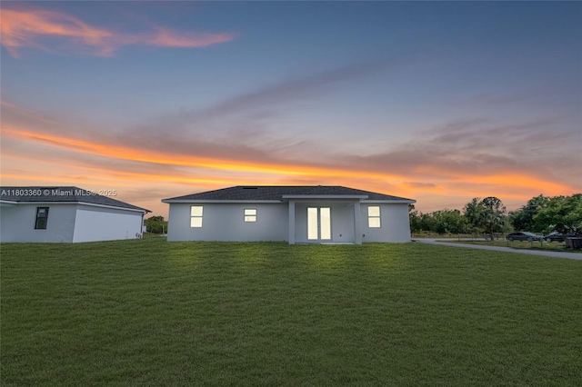 2506 5th St SW, Lehigh Acres, FL 33976 - property exterior at dusk with a lawn and stucco siding