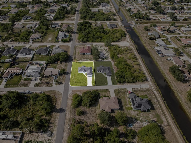 2506 5th St SW, Lehigh Acres, FL 33976 - aerial view of property and surrounding area with nearby suburban area and a large body of water