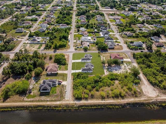 2506 5th St SW, Lehigh Acres, FL 33976 - aerial view of property and surrounding area with a large body of water and nearby suburban area