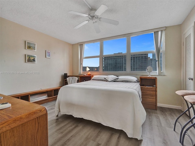 3113 S Ocean Dr Unit 603, Hallandale Beach, FL 33009 - bedroom with a textured ceiling, light wood finished floors, baseboards, and a ceiling fan