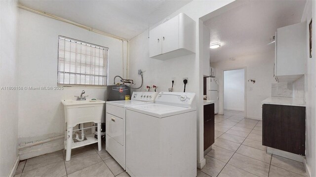 18502 NW 23rd Ct, Miami Gardens, FL 33056 - washroom featuring separate washer and dryer, cabinet space, water heater, and light tile patterned flooring
