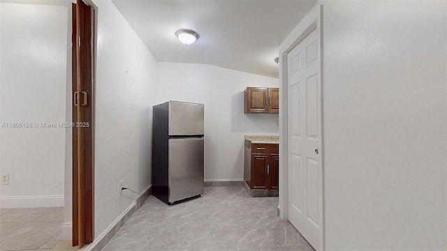 18502 NW 23rd Ct, Miami Gardens, FL 33056 - kitchen featuring freestanding refrigerator, vaulted ceiling, and light countertops