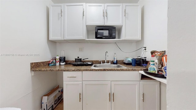18502 NW 23rd Ct, Miami Gardens, FL 33056 - kitchen with black microwave and white cabinets