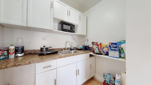 18502 NW 23rd Ct, Miami Gardens, FL 33056 - kitchen featuring black microwave and white cabinetry