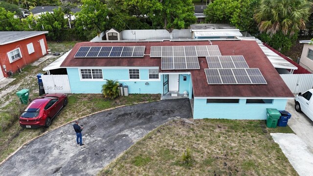 18502 NW 23rd Ct, Miami Gardens, FL 33056 - view of front facade featuring solar panels, stucco siding, and asphalt driveway
