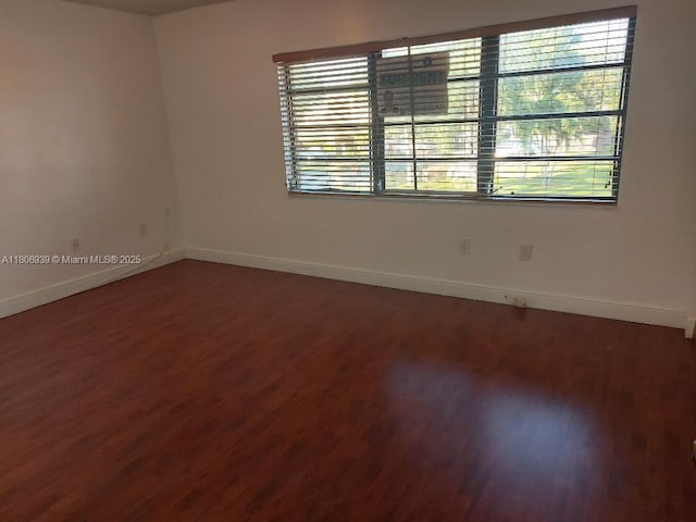 20033 NE 2nd Pl, Miami, FL 33179 - empty room featuring baseboards and wood finished floors