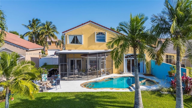 1060 NW 192nd Ave, Pembroke Pines, FL 33029 - back of property featuring a sunroom, a patio area, stucco siding, a yard, and a pool with connected hot tub