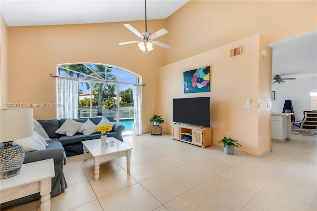 1060 NW 192nd Ave, Pembroke Pines, FL 33029 - living room with a ceiling fan, a towering ceiling, light tile patterned floors, and baseboards