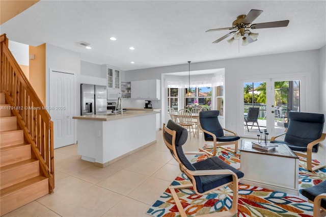 1060 NW 192nd Ave, Pembroke Pines, FL 33029 - kitchen featuring stainless steel fridge with ice dispenser, light countertops, white cabinetry, light tile patterned flooring, and recessed lighting