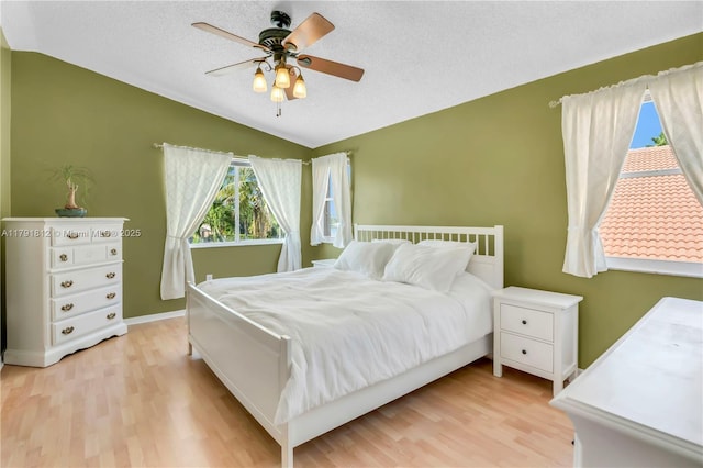 1060 NW 192nd Ave, Pembroke Pines, FL 33029 - bedroom featuring vaulted ceiling, light wood-style flooring, a textured ceiling, and ceiling fan